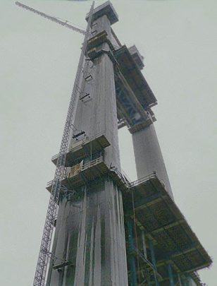 Construction site featuring tall building columns and scaffolding, showcasing the process of structural development and engineering.