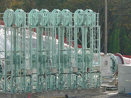 Industrial Equipment Assembly A series of industrial machinery featuring multiple large green wheels and mechanical components, designed for operational efficiency.