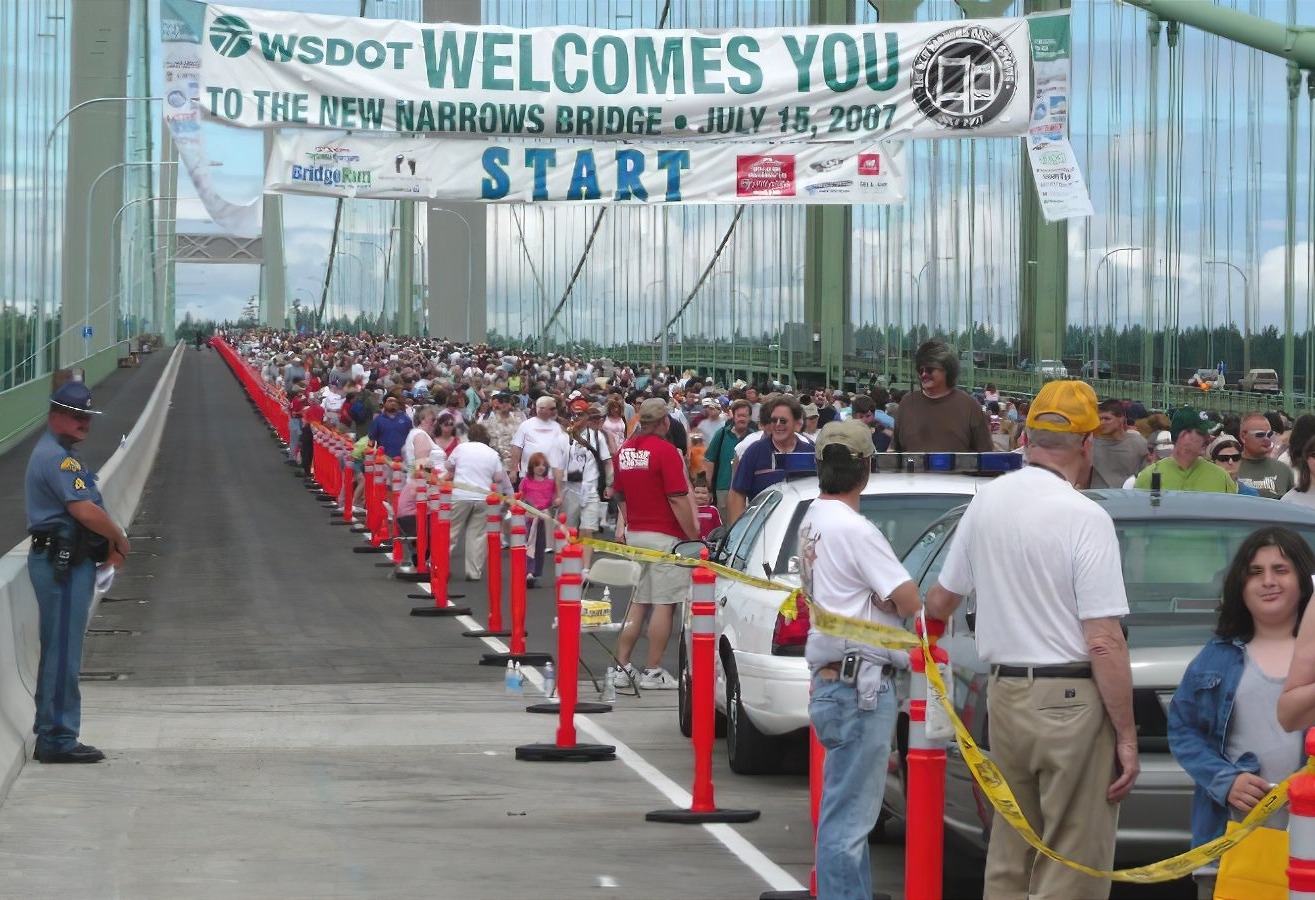 New Narrows Bridge Opening Day Crowd Large crowd gathered at the New Narrows Bridge opening day event, with police presence and traffic cones visible.