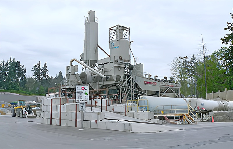 Concrete mixing plant with silos and equipment for processing materials at a construction site.