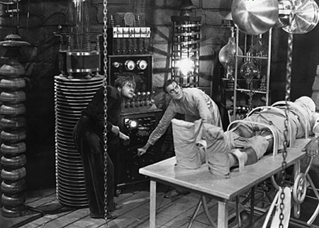 Classic Frankenstein laboratory scene with characters operating machinery and a figure on a table, showcasing the iconic horror theme.